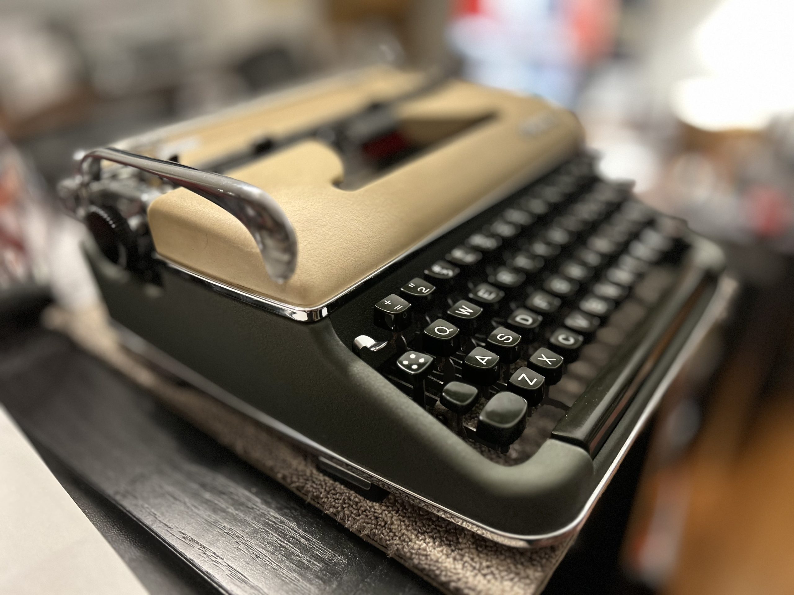 Photo of a 1957 Olympia SM3 manual typewriter in two-tone paint scheme of tan/green
